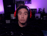 a man wearing red headphones is making a funny face in front of a youtube sign