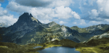 a mountain with a lake in the foreground