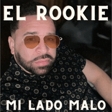 a man wearing sunglasses and a black shirt with the words el rookie mi lado malo on the bottom