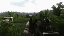 a person holding a gun in a video game with a tank in the background