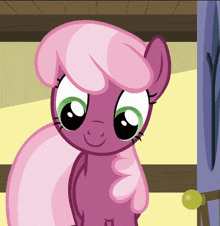 a pink pony with green eyes and a pink mane