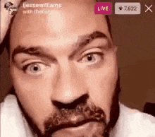 a close up of a man 's face with a beard and a beard dye on it .