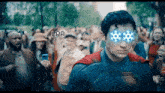 a man in a superman costume is standing in front of a crowd with lpp written on the bottom