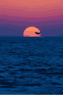 a whale is jumping into the ocean at sunset .