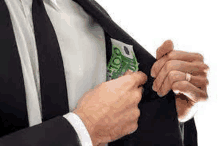 a man in a suit and tie is putting money in his pocket .