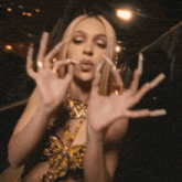 a woman with long nails and a butterfly top