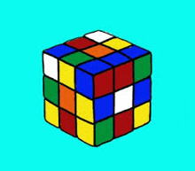 a colorful rubik 's cube is sitting on a blue surface .