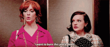 two women are standing next to each other in an elevator and one of them is saying i want to burn this place down .