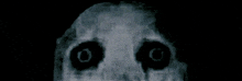 a close up of a person 's face with glowing black eyes