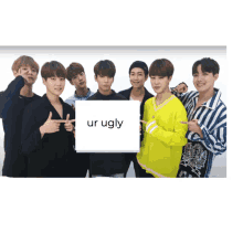 a group of young men holding a sign that says " ur ugly "