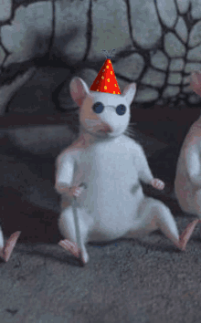 a white mouse wearing a red party hat and glasses