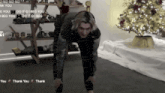 a man is doing a stretching exercise in front of a christmas tree ..