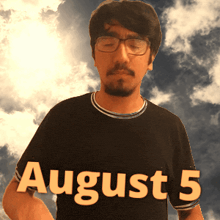 a man wearing glasses and a black shirt with the date august 5