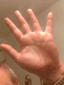 a close up of a person 's hand reaching out