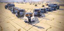 a man stands in front of a group of cars in a desert