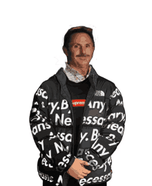 a man with a mustache wears a jacket that says " any " on it