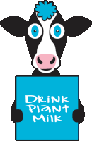 a cow with a pink flower on its head is holding a sign that says drink plant milk