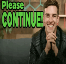 a man in a leather jacket is smiling in front of a sign that says please continue