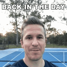 a man is standing in front of a tennis court with the words back in the day written above him