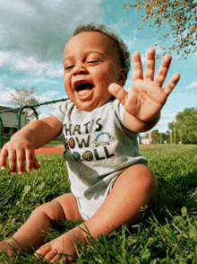 a baby wearing a shirt that says ' that 's how i roll ' on it