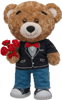 a teddy bear is wearing a tuxedo and holding roses