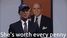 a man in a suit and tie says she 's worth every penny in front of a picture of two men
