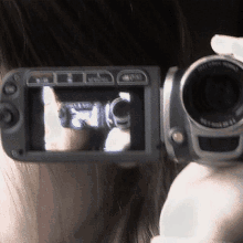 a person is taking a picture with a video camera that says ' fujinon ' on the lens