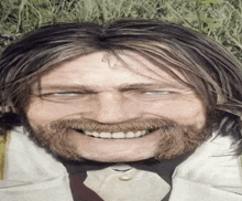 a man with long hair and a beard is smiling with his eyes closed