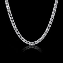 a silver chain on a black background with a reflection .