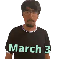 a man wearing glasses and a black shirt with march 3 on it