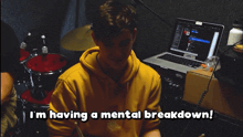 a man sitting in front of a laptop with the words i 'm having a mental breakdown below him