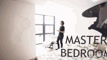 a woman stands in a bedroom with the words " master bedroom " written on the wall