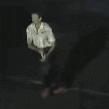 a person is standing in the dark with a shadow on the floor .