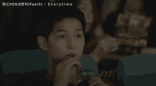 a young man drinking from a straw in a movie theater with the words " everytime " on the bottom