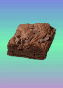 a brownie with chocolate chips on top of it on a blue and green background