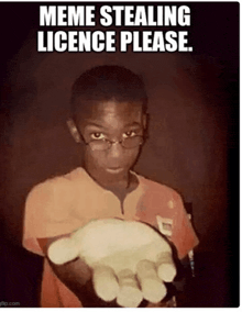 a young boy with glasses is holding something in his hand with the caption meme stealing licence please .