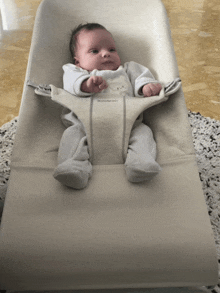 a baby is sitting in a bouncer that says ' babybjörn ' on it