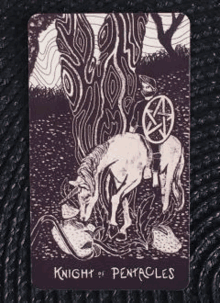 the knight of pentacles tarot card is a black and white painting of a man riding a horse .