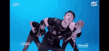 a group of men are dancing on a blue background .