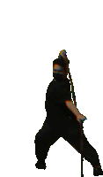 a man in a ninja costume is holding a stick