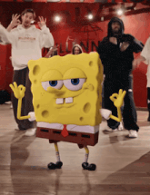 a group of people are dancing in front of a sign that says " millennium "