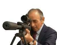 a man in a suit and tie is holding a sniper rifle with a scope .