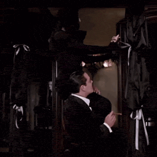 a man and a woman are dancing in a room .