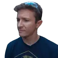a man in a black shirt with a yellow triangle on it