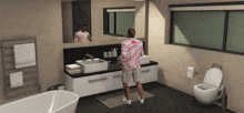 a man in a pink shirt with the word supreme on it stands in a bathroom