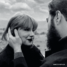 a black and white photo of a man touching a woman 's face with the words swifter pics below them