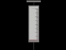 a syringe with a red liquid in it and a ruler