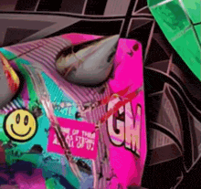 a close up of a gm sticker on a colorful background