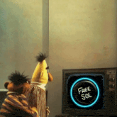 two sesame street characters are looking at a free sol button on a television screen
