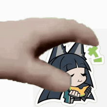 a hand is holding a sticker of a cartoon girl with a cat ears .